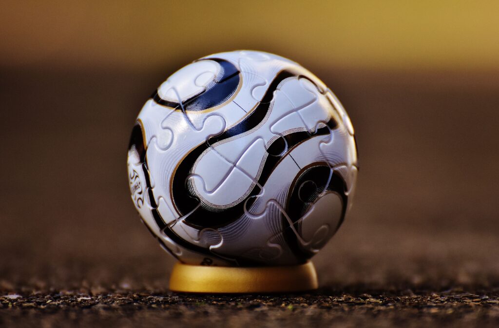 Macro shot of a soccer-themed puzzle ball on a stand, showcasing intricate details.